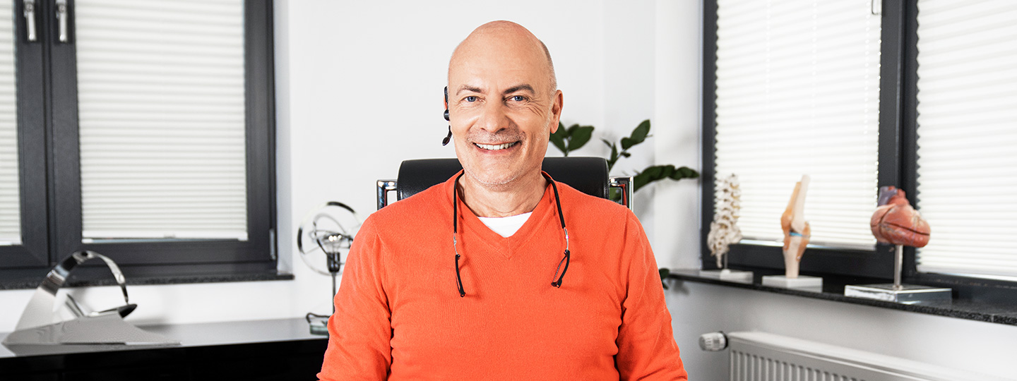 Facharzt für Allgemeinmedizin Dr. med. Markus Bruckhaus-Walter sitzt in seinem Sprechzimmer