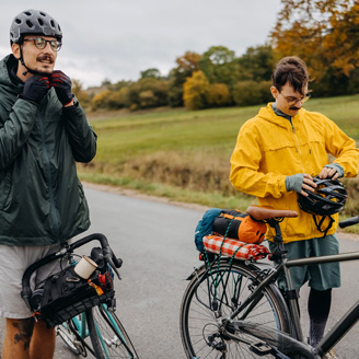 Zwei junge Männer machen sich bereit für eine Fahrradtour. Zwei junge Männer machen sich bereit für eine Fahrradtour.